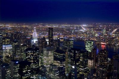 Aerial view of city lit up at night