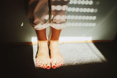 Low section of woman standing at home