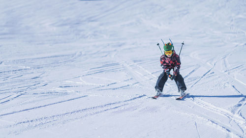 Boy skiing on snowcapped mountain