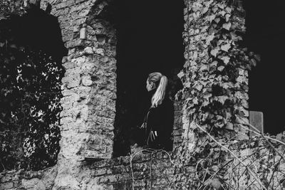 Portrait of woman standing by plants