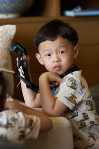 Portrait of cute boy sitting at home