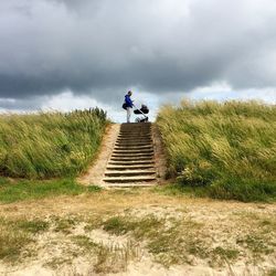 Low angle view of people on staircase against sky