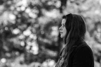 Portrait of a young woman looking away outdoors