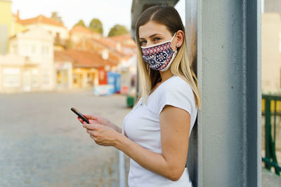 Portrait of young woman using mobile phone