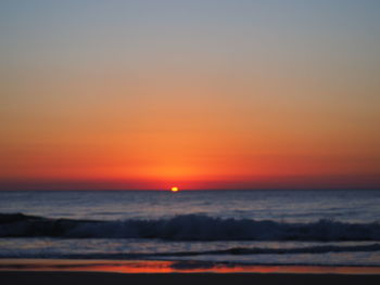 Scenic view of sea against romantic sky at sunset