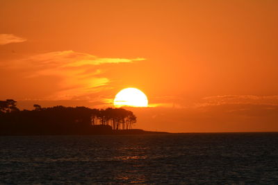 Scenic view of sea against orange sky