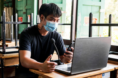 Man using laptop at table