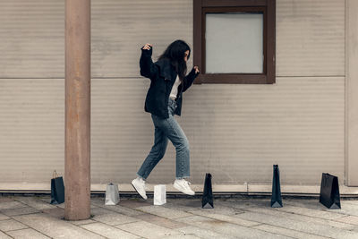 Happy young woman rejoices in good shopping. girl with shopping bags.