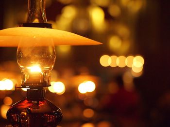 Close-up of illuminated light bulb on table