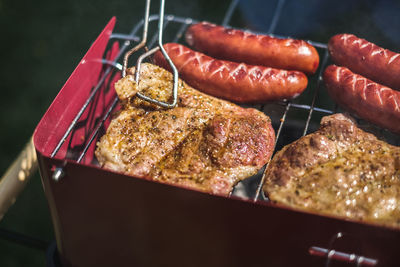 High angle view of meat on barbecue grill