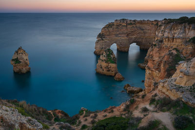 Natural arch cliffs of praia da marinha beach at sunset beautiful landscape in lagoa portugal