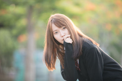 Portrait of young woman standing outdoors