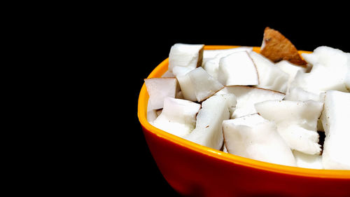 Close-up of ice cream in bowl against black background