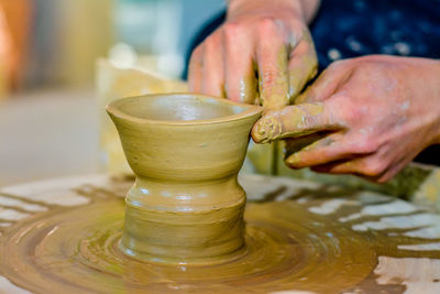 Close-up of man making pottery