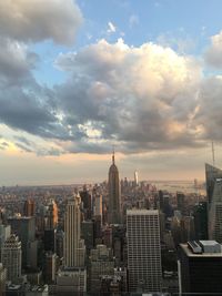 Buildings in city against cloudy sky