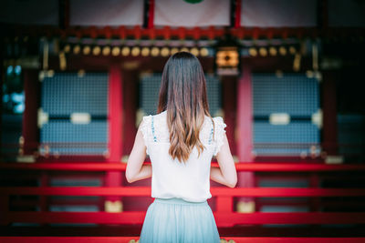 Rear view of woman standing outdoors