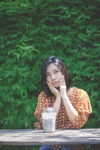 Portrait of a beautiful young woman drinking water