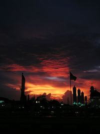 Silhouette buildings against sky during sunset