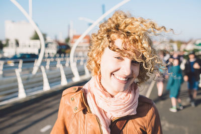 Portrait of smiling woman against sky