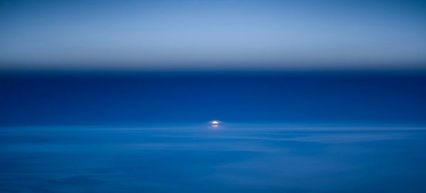 Scenic view of sea against blue sky