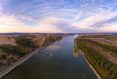 Juromenha castle, village and boat in guadiana river drone aerial view at sunset in alentejo