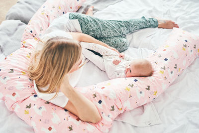 High angle view of baby sleeping in bed