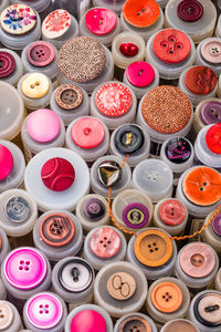 Close-up of colourful yarn reels on the sales stand of a flea market