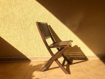 Minimalistic shot of wooden chair sitting in the bright sunlight