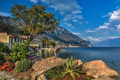 Scenic view of sea and mountains against sky