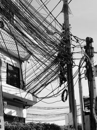 Low angle view of electricity pylon against sky