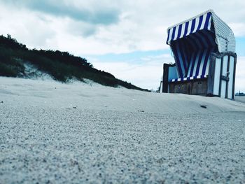 Surface level of road on beach against sky