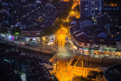 High angle view of illuminated buildings in city at night