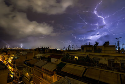 Lightning over city against sky at night