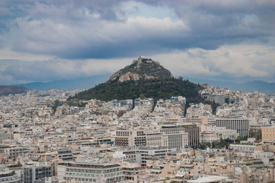 Aerial view of town against cloudy sky