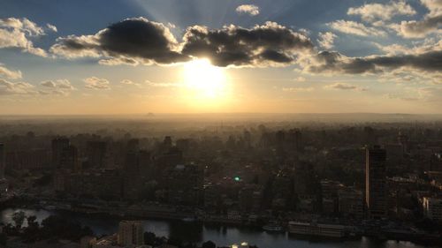 High angle view of city buildings against sky during sunset