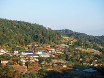 Scenic view of trees and buildings against clear sky