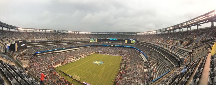 High angle view of people in stadium against sky