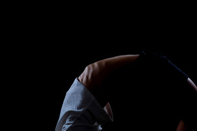 Close-up of woman's hand against black background