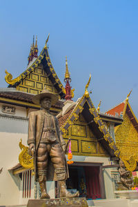 Low angle view of statue against building