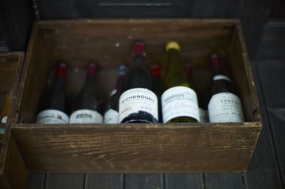 High angle view of wine bottles in wooden box