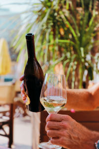 Close-up of hand holding glass bottle