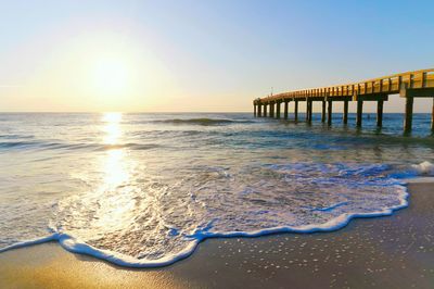 Scenic view of sea against clear sky during sunset