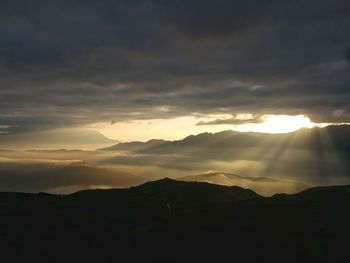 Scenic view of silhouette mountains against sky during sunset