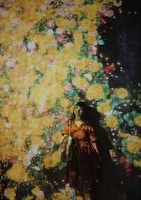 Woman standing in autumn leaves