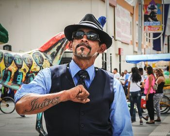 Portrait of man wearing sunglasses standing outdoors