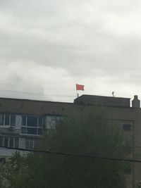 Low angle view of building against cloudy sky