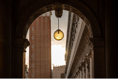 Illuminated pendant lights hanging from ceiling of building