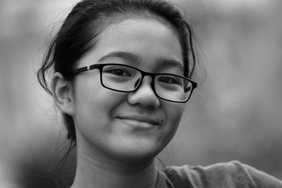 Black and white portrait of a natural look of a young girl wearing glasses 