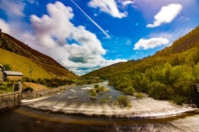 Road by mountain against sky