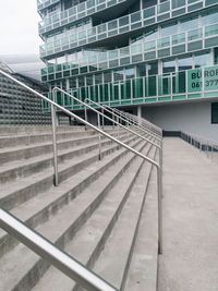 Staircase of modern building in city against sky